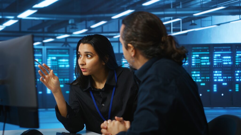 Colleagues examining infrastructure in data center
